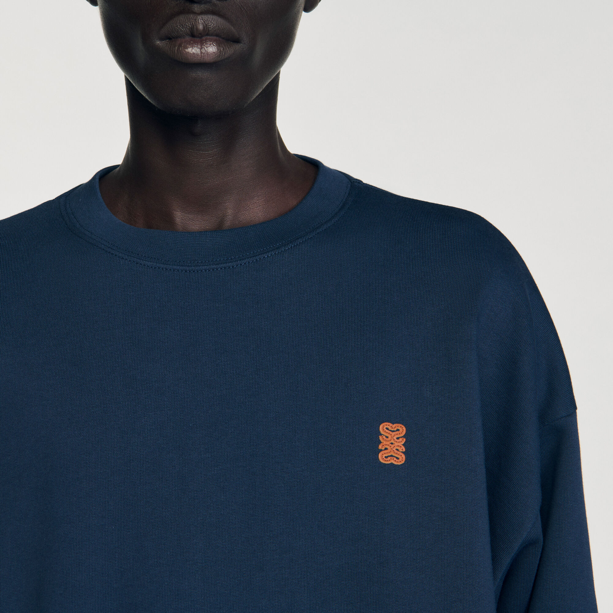 Oversized sweatshirt with leather patch