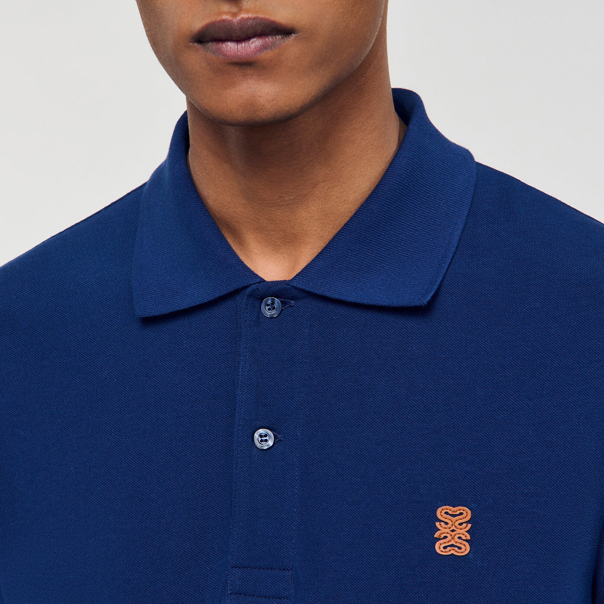 Polo shirt with leather logo