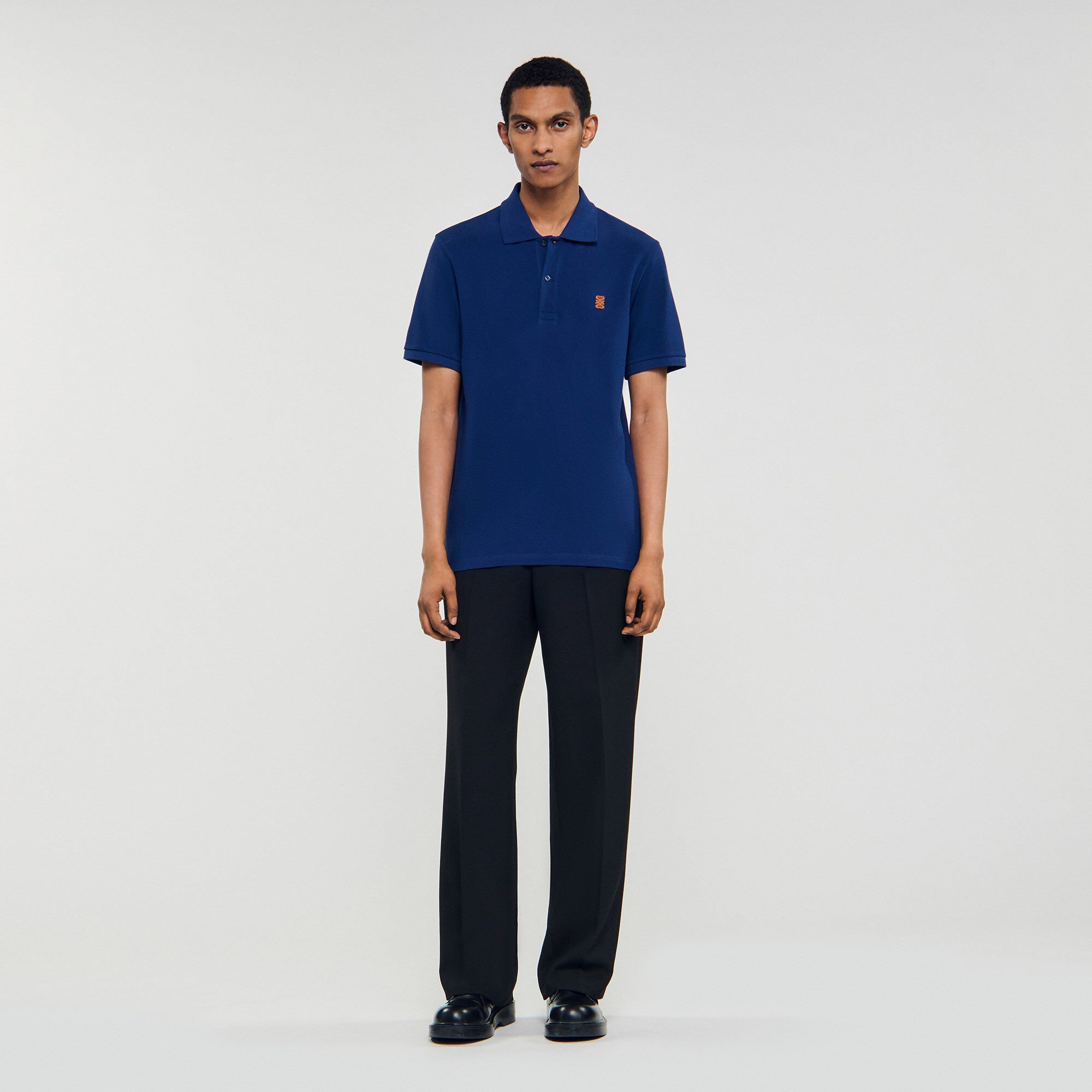 Polo shirt with leather logo